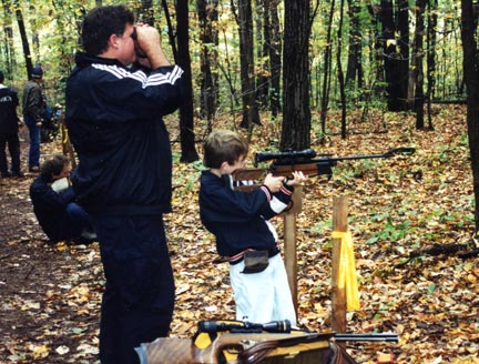Field target shooter spots for his son