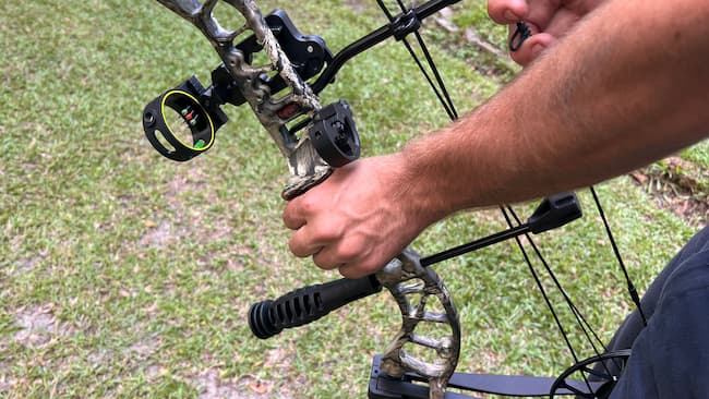 archer gripping bow with nondominant hand